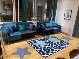 a living room with a blue couch and blue pillows at Central Sheffield 3BED 3BATH IV Pent-Apartment in Sheffield