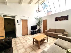 a living room with a couch and a table at Heritage House Apartments in Swindon