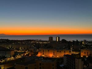 a view of a city at sunset at Sun Apartments in Torremolinos