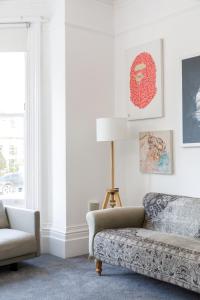 a living room with a couch and a chair at Lovely, modern & spacious 1-bed flat central Hove in Brighton & Hove