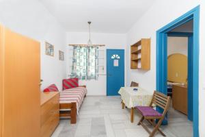 a room with a couch and a table and a door at Astra Apartments in Agios Prokopios