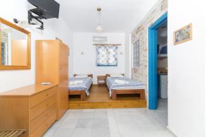 a living room with two beds and a table at Astra Apartments in Agios Prokopios