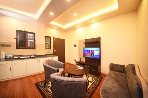 a living room with two couches and a tv at Friends Apartment Pvt.Ltd in Kathmandu