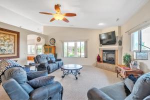 a living room with couches and a ceiling fan at Prescott Luxury Home near Golf Course and Airport home in Prescott Valley