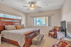 a bedroom with a bed and a ceiling fan at Prescott Luxury Home near Golf Course and Airport home in Prescott Valley
