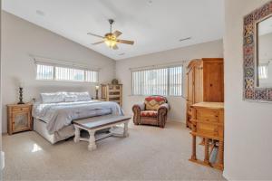a bedroom with a bed and a ceiling fan at Prescott Luxury Home near Golf Course and Airport home in Prescott Valley