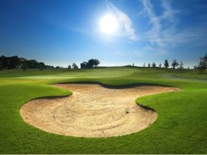 a golf course with a sand bunker on a green field at Prescott Luxury Home near Golf Course and Airport home in Prescott Valley