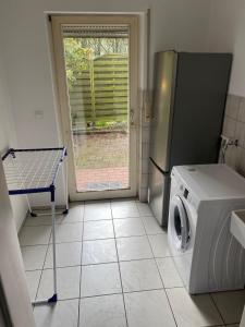 a kitchen with a refrigerator and a washing machine at Gästehaus am Biener See in Schepsdorf