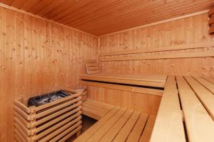an empty wooden sauna with a bench in it at Sunee Apartment in Kranjska Gora