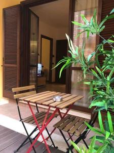 a wooden table and two chairs on a patio at Appartamento Montebello in Terni