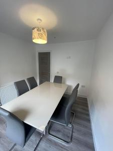 a conference room with a white table and chairs at The great escape in Skerries