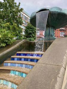 a water fountain with stairs in a city at Central Sheffield 3BED 3BATH V Pent-Apartment in Sheffield