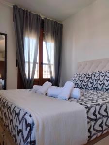 a bedroom with two beds and a window at La Colina Golf & Beach in Huelva