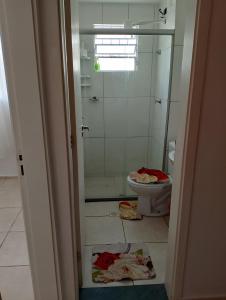 a bathroom with a shower and a toilet in it at Apartamento Padrão 1° andar in Vespasiano