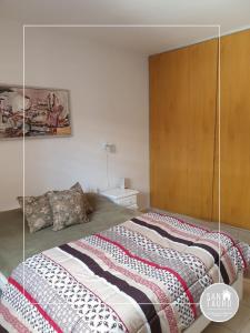 a bedroom with a bed with a glass wall at SAN TAURO VIEDMA in Viedma