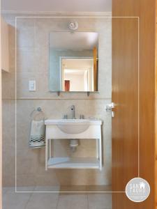a bathroom with a sink and a mirror at SAN TAURO VIEDMA in Viedma