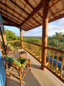 a porch with chairs and a view of the ocean at Céu e Mar Itacaré in Itacaré +56 photos