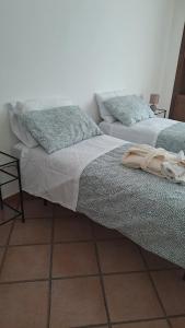 two beds sitting next to each other in a room at La casa nel borgo in Bracciano +23 photos