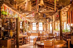 a restaurant with wooden tables and chairs and bottles at Loft Sousas in Campinas