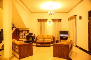 a large living room with couches and a tv at Villa71 in Galle