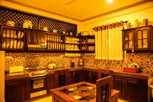 a kitchen with wooden cabinets and a stove top oven at Villa71 in Galle