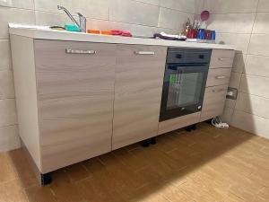 a kitchen counter with a sink and a dishwasher at DOLCEVITA PONTE MILVIO in Rome