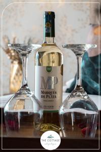 - une bouteille de vin à côté de deux verres dans l'établissement The Cottage Angochagua, à Ibarra