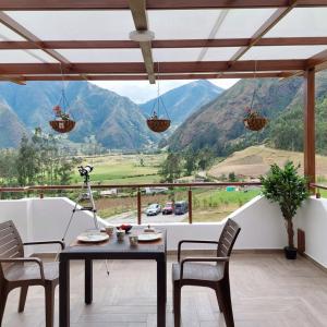 a dining room with a view of mountains at The Cottage Angochagua in Ibarra