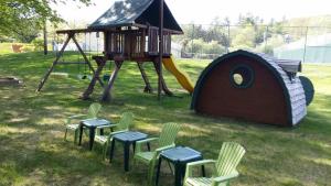 a playground with chairs and a play structure at The Lodge at Jackson Village in Jackson
