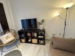 a living room with a flat screen tv on a shelf at Casa de Eugenia in Málaga