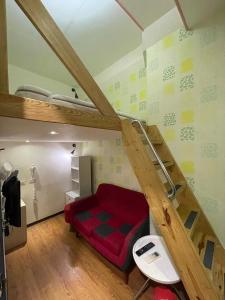 a room with a loft bed with a red mattress at Dream Travel in Taipei