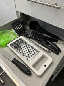 a kitchen counter with a cutting board and utensils at Practical and Spacious Property in Stoke on Trent