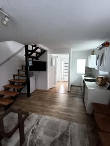 a living room with a staircase and a kitchen at Vila Vasilisa in Prijepolje