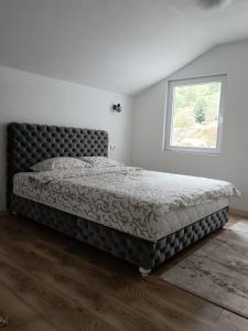 1 cama grande en un dormitorio con ventana en Vila Vasilisa, en Prijepolje