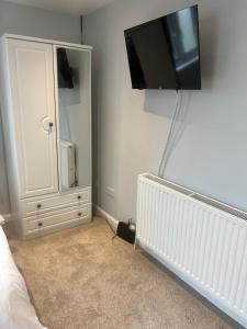 a bedroom with a flat screen tv on the wall at 29a in Downham Market
