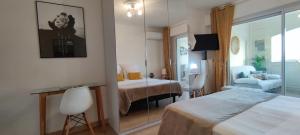 een hotelkamer met een bed en een spiegel bij La Goelette - Palais des Festivals in Cannes