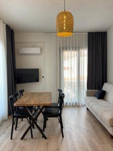 a living room with a table and chairs and a couch at Aden Apart Otel in Fethiye
