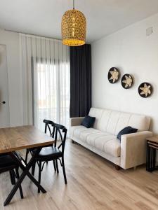 a living room with a white couch and a table at Aden Apart Otel in Fethiye