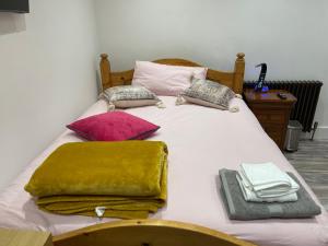 a white bed with blankets and pillows on it at Luxury Rooms with En-suite bathrooms - West London in Harrow on the Hill