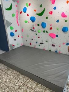 a room with a climbing wall with a bed in it at Heyyo Hostel in Hualien City