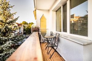 a balcony with chairs and a table and a christmas tree at G15 Apartment in Olsztyn