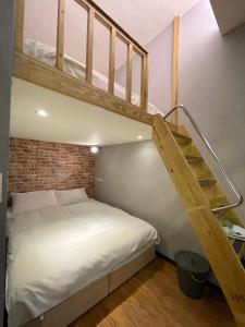 a bedroom with a bunk bed and a staircase at Dream Travel in Taipei