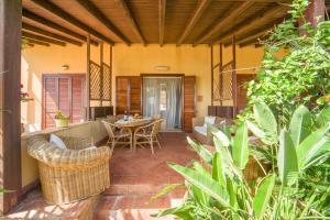 an outdoor patio with a table and chairs at Casa Belìce in Marinella di Selinunte