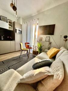 a living room with a couch and a dining room at Design Home at garda Lake in Desenzano del Garda
