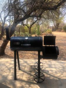 a black machine sitting on a table in a park at Comfortable cottage in Big 5 Game Reserve in Dinokeng Game Reserve