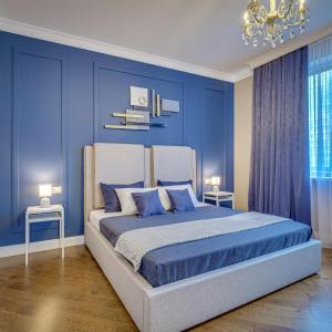 1 dormitorio azul con 1 cama grande y paredes azules en Asaapart AFD Plaza, en Almaty