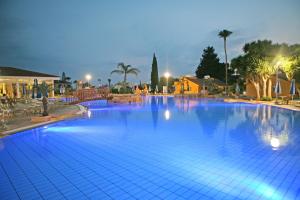 a large swimming pool with blue lights on it at Makronisos Village in Ayia Napa