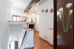 a kitchen with a white counter and a fireplace at La Casa nel Borgo in Stimigliano