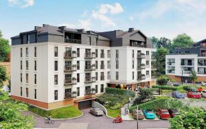 a rendering of a building with cars parked in a parking lot at Benefis Tatarska in Przemyśl