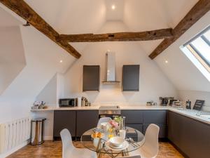 a kitchen and dining room with a table and chairs at Pass the Keys 5C Charming Town Centre Apartment With Roof Top Views in Shrewsbury +8 photos